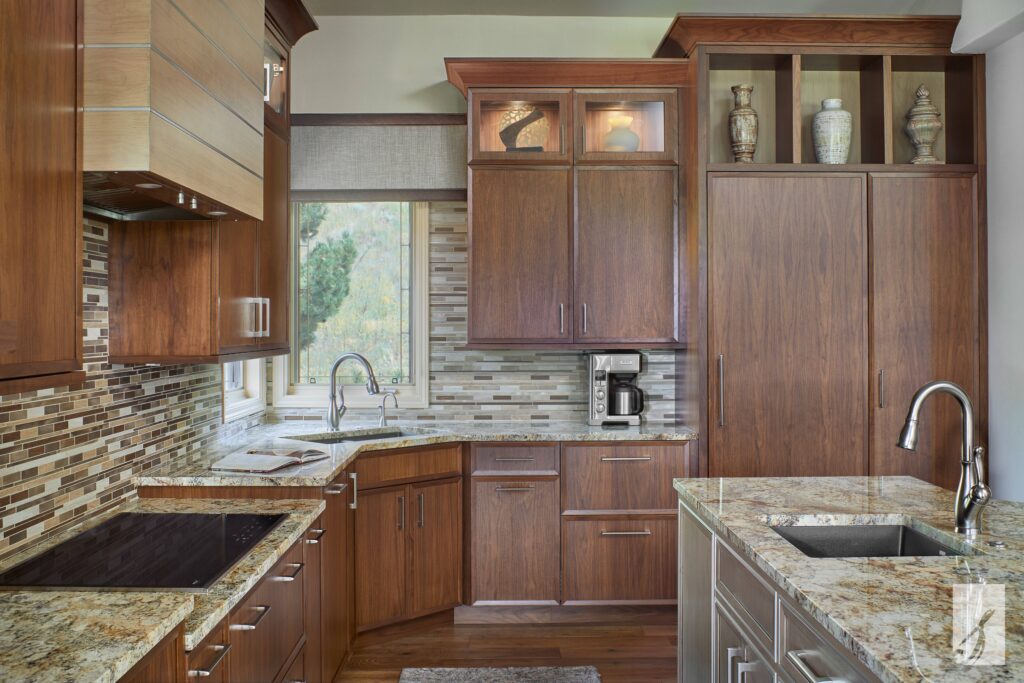 A kitchen with small horizontal tile backsplash and rich, brown wood cabinetry.