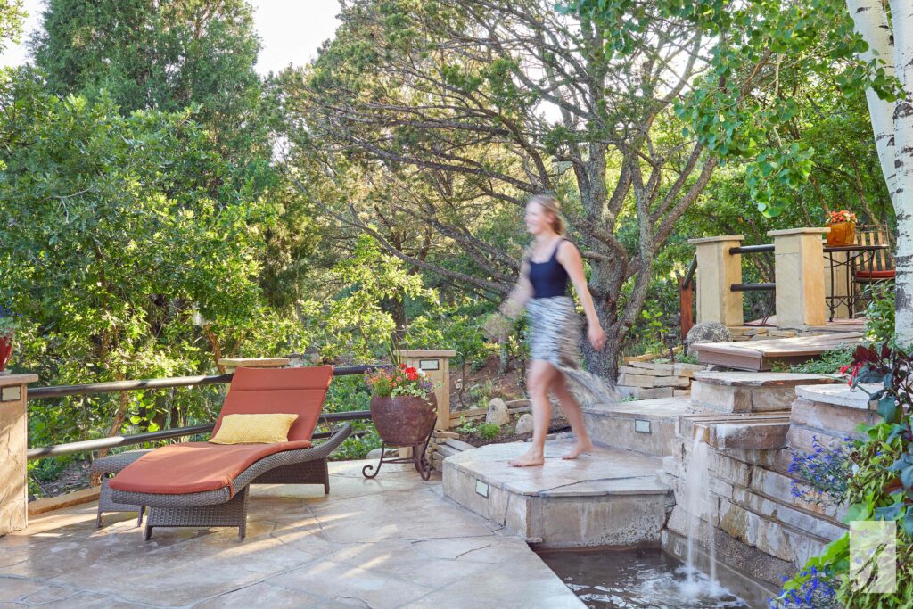 Courtney Sikora walking across a client's patio near Colorado Springs, Colorado (CO)