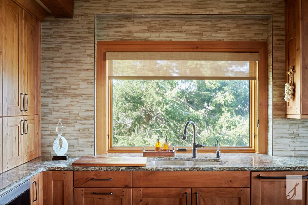 Hunter Douglas Provenance® Woven Wood Shades in a wood kitchen at Speas Interior Design near Colorado Springs, Colorado (CO)