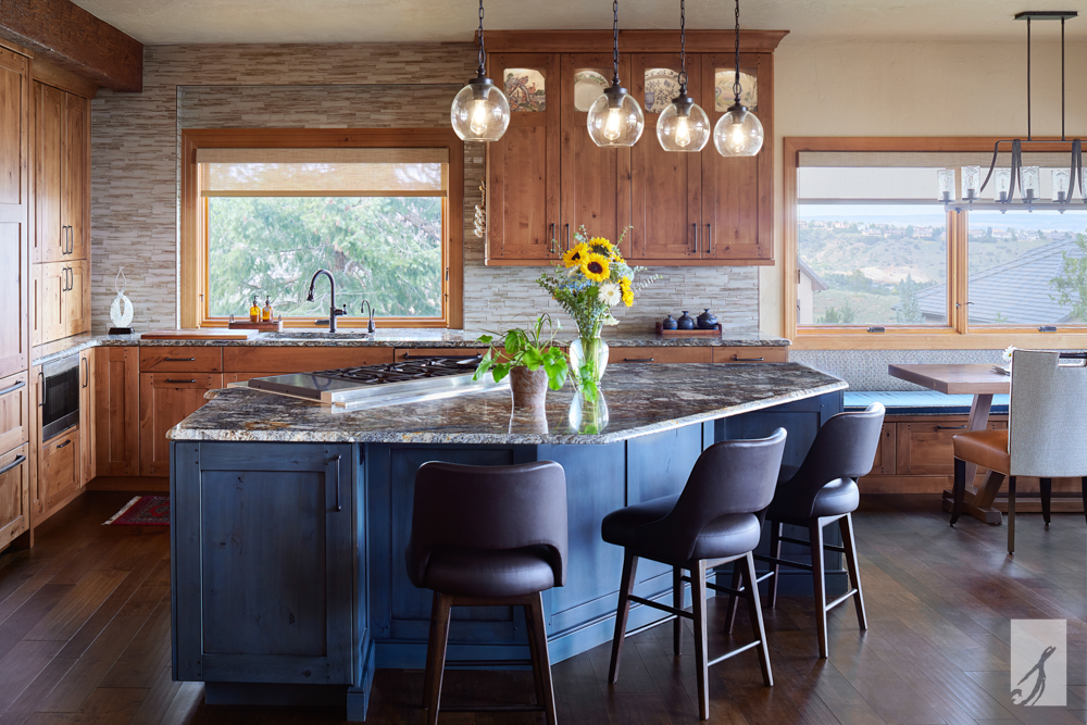 A kitchen with blue and stained wood cabinetry.