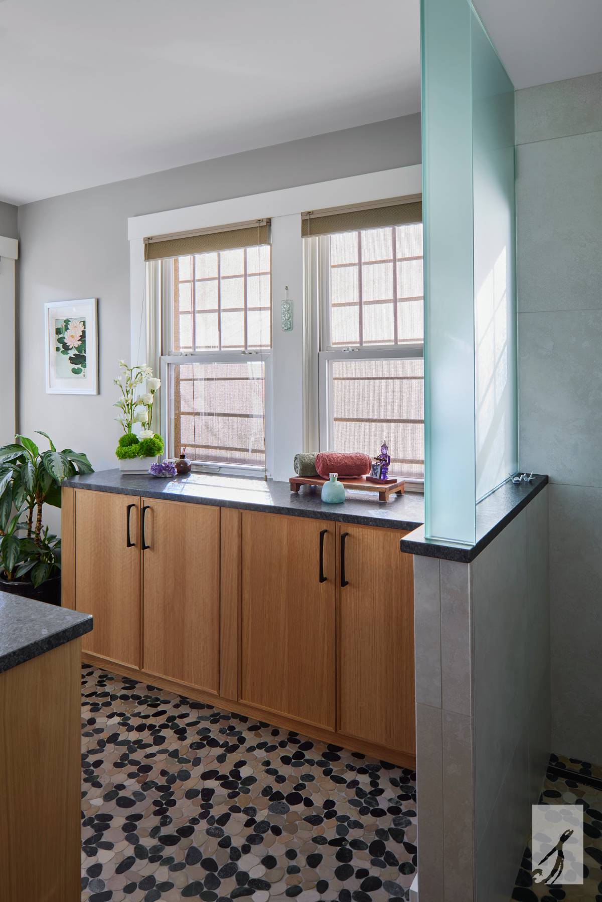 Wooden storage cabinetry with rolled towels in a contemporary space