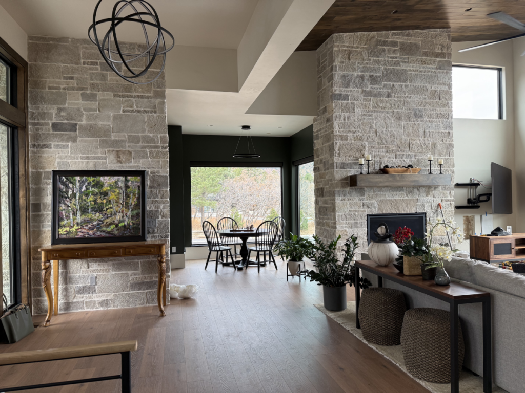 A welcoming entryway with stone walls and layered lighting in a Colorado Springs home