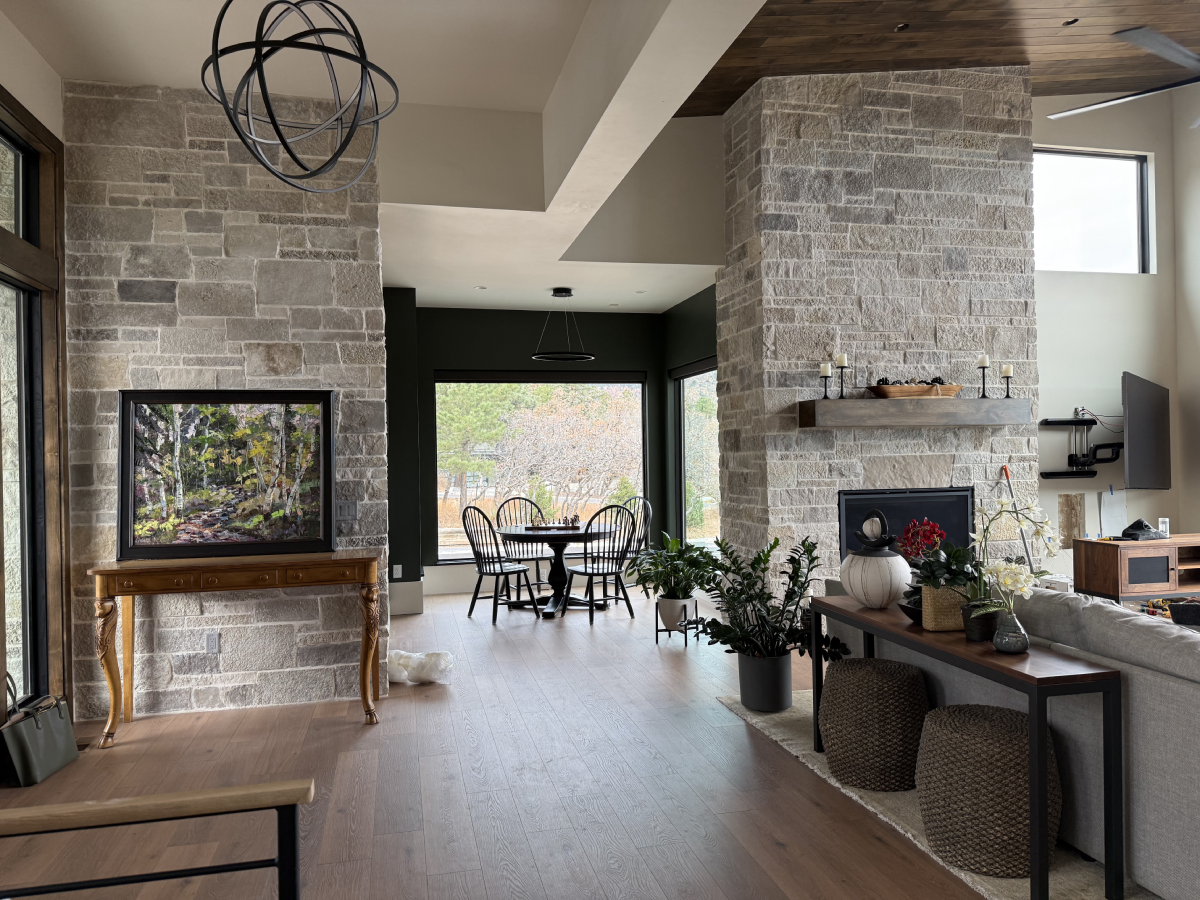 A welcoming entryway with stone walls and layered lighting in a Colorado Springs home