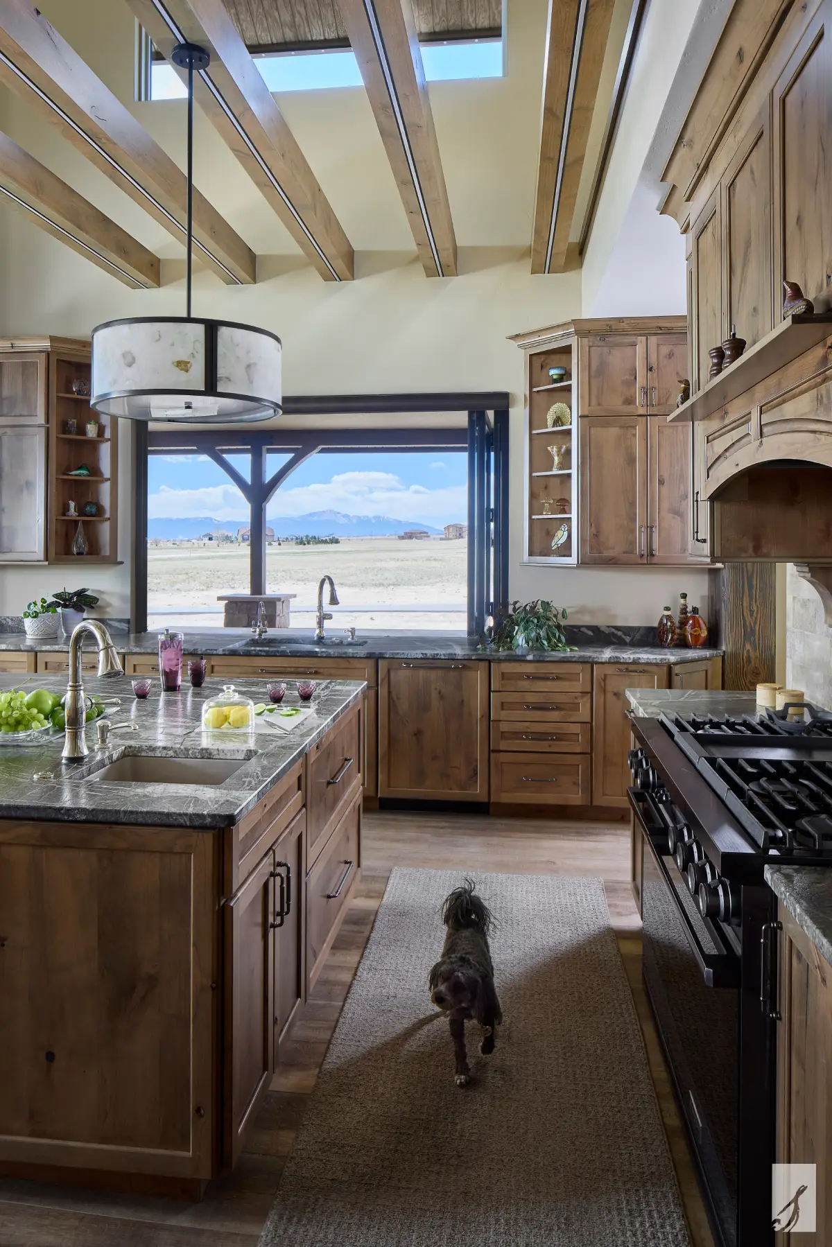 Bypass windows fully retracted between an interior kitchen and the deck beyond