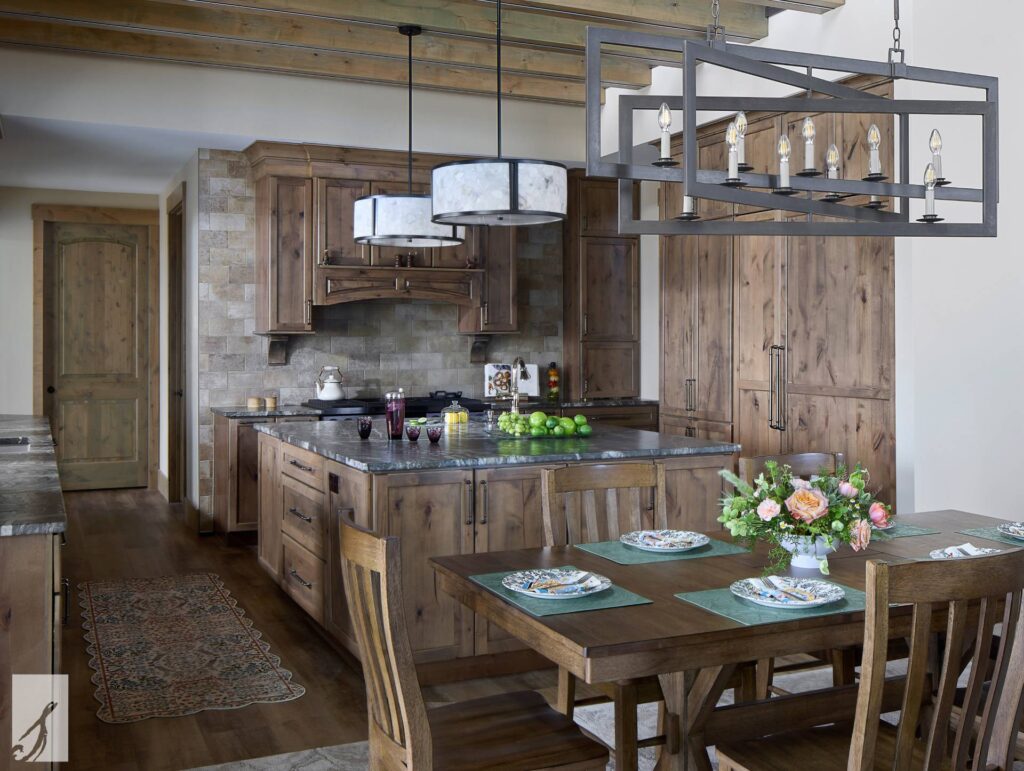 Wood kitchen with stone backsplash, custom hood and linear metal chandelier