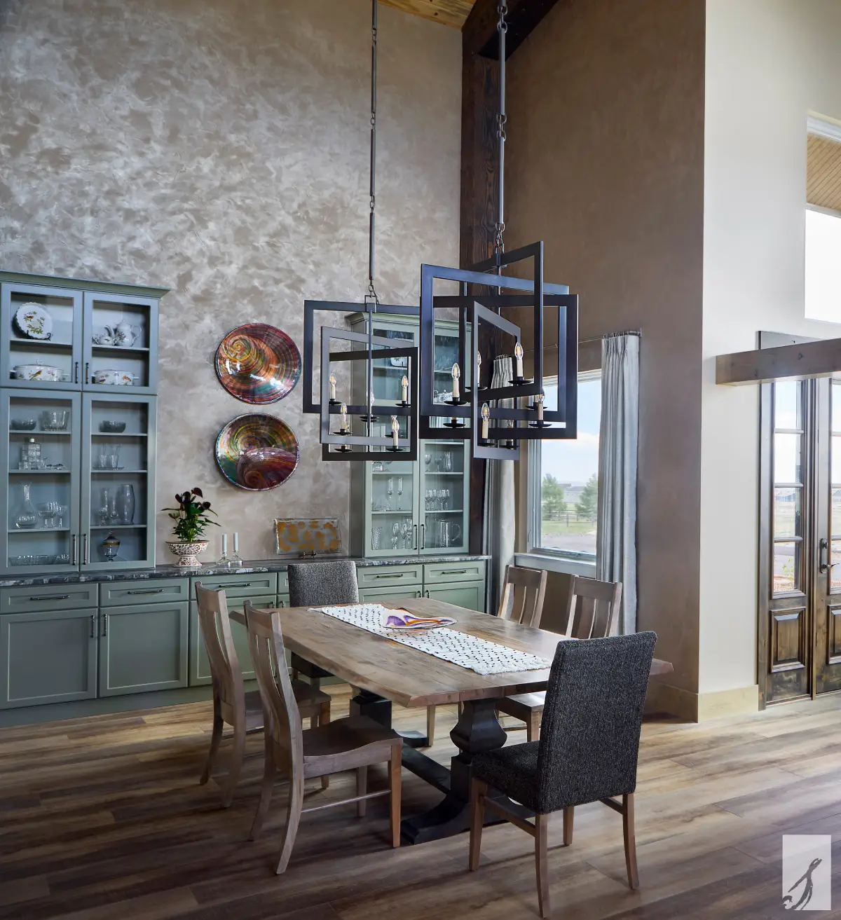 Interlined custom drapery side panels framing window in a tall Colorado Springs dining room