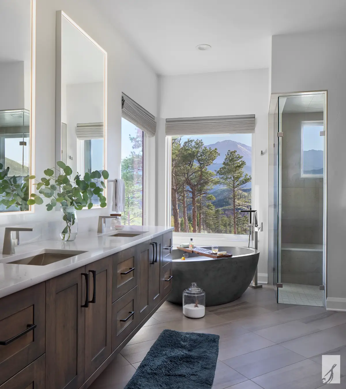 Evergreen Mountain Haven primary bathroom with a Native Trails concrete soaking tub, stained-wood double vanity, and expansive mountain views